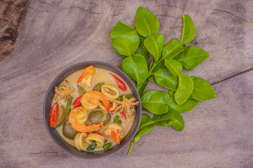 Thai food chicken green curry on dark wooden background. top view