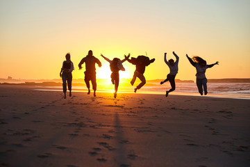 Fototapeta premium Friends jumping on a sunny beach