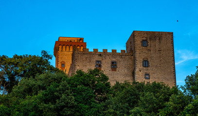 Fototapeta na wymiar Medieval building, old town with towers, bright blue sky in the background, typical Italy and Tuscany countryside landscape.