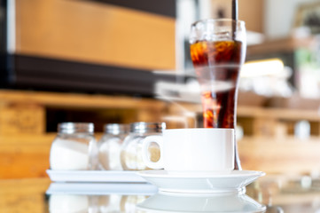 Cup of hot Coffee with smoke on wooden table in coffee shop