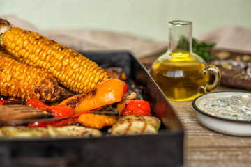 Grilled corn cobs with vegetables, spice, garlic, Healthy, organic, homemade food. Toned image.