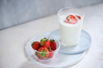 Strawberry homemade yogurt with fresh strawberries on white table