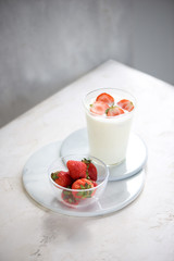 Fresh strawberry on a glass with dessert yogurt and strawberry  on white background