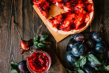 Delicious dessert plum pie, sweet delicious holiday cake with fresh plums. Top view, flat lay background. Copy space.