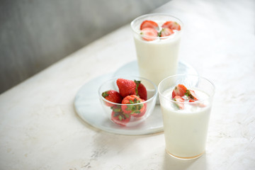 Fresh strawberry on a glass with dessert yogurt and strawberry  on white background