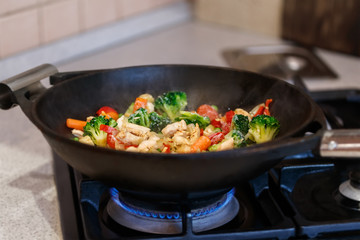 turkey meat stew with fresh vegetables cooked in a wok pan