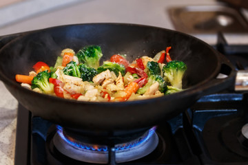 turkey meat stew with fresh vegetables cooked in a wok pan