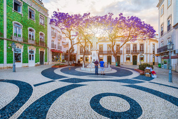 Street in the old town in the center of Lagos, Algarve region, Portugal. Narrow street in Lagos, Algarve, Portugal. Streets in the historic old town of Lagos, Algarve, Portugal. - obrazy, fototapety, plakaty