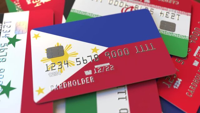 Many credit cards with different flags, emphasized bank card with flag of Philippines