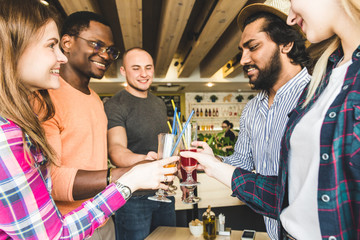 Meet young attractive people in the cafe. Friends chat, have fun, drink cocktails and eat