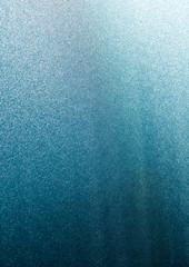 vertical gradient background of bright light and blue through rippled glass