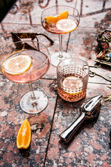 Rose wine in wineglasses. Wine tasting, garden party and celebration in the summer. Still life and lifestyle in the garden with artistic shadows.