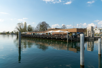 people enjoy dining out in the harbor restaurant on the lake in the city of Zug