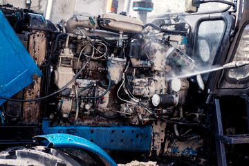 Fototapeta premium Tractor maintenance. Engine washing, cooling tractor engine system.