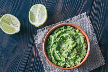 Bowl of guacamole on the wooden table