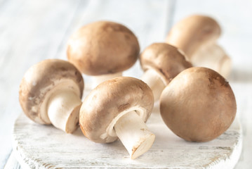 Champignon mushrooms on the wooden board
