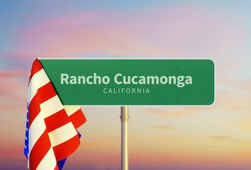 Rancho Cucamonga – California. Road or Town Sign. Flag of the united states. Sunset oder Sunrise Sky