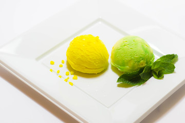 Set of ice cream scoops of different colors and flavours with fruits decoration isolated on white background 