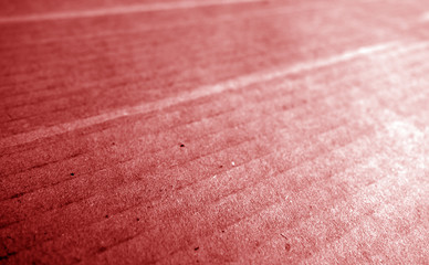 Cardboard close-up with blur effect in red tone.