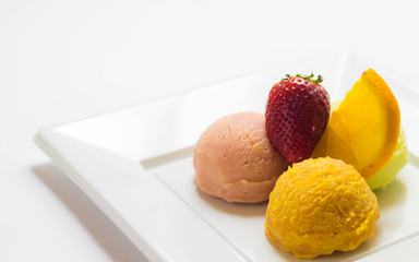 Set of ice cream scoops of different colors and flavours with fruits decoration isolated on white background 