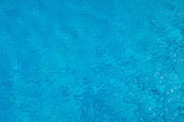 Blue ripped water in swimming pool. Surface of blue swimming pool, background of water in swimming pool. Water swimming pool texture and surface water on pool. Blue ripped water in swimming pool.