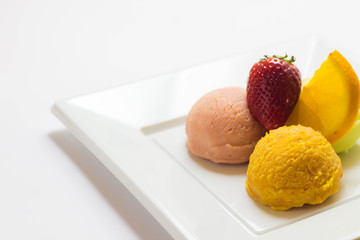 Set of ice cream scoops of different colors and flavours with fruits decoration isolated on white background 