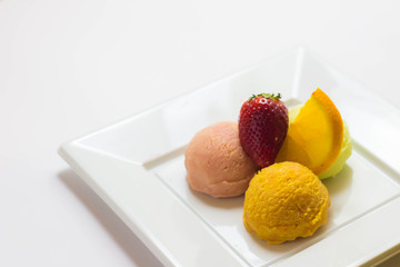 Set of ice cream scoops of different colors and flavours with fruits decoration isolated on white background 
