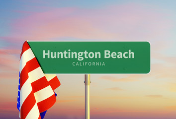 Huntington Beach – California. Road or Town Sign. Flag of the united states. Sunset oder Sunrise Sky