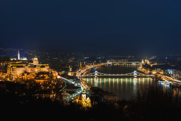 Fototapeta na wymiar Night view of Budapest. Cityscape of famous tourist destination with Danube and bridges. Travel illuminated landscape in Hungary, Europe.