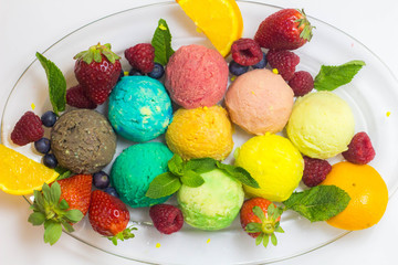 Set of ice cream scoops of different colors and flavours with fruits decoration isolated on white background 