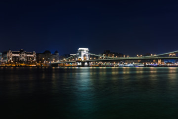 Obraz premium Night view of Budapest. Panorama cityscape of famous tourist destination with Danube and bridges. Travel illuminated landscape in Hungary, Europe.