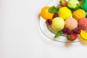 Set of ice cream scoops of different colors and flavours with fruits decoration isolated on white background 