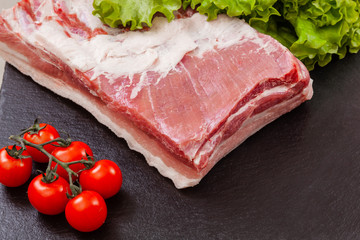 a piece of pork meat on the black plate