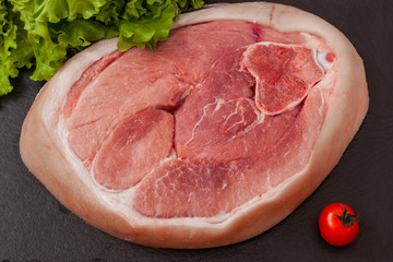 a piece of pork meat on the black plate