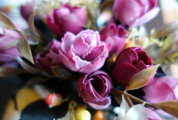 Naklejka na ściany i meble Artificial flowers boquet close up with blur effect.