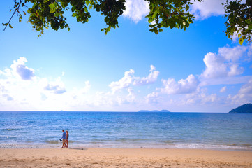 Pulau Tioman, Malaysia - 6 April 2019, Happy romantic couple enjoying beautiful ocean walk on the beach. Travel Vacation Lifestyle Concept.