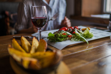 Potatoes fried in a pan, rustic style. Eating and leisure concept. Roasted potato. Delicious hot potatoes. Organic healthy food. Toned image. Selective focus.
