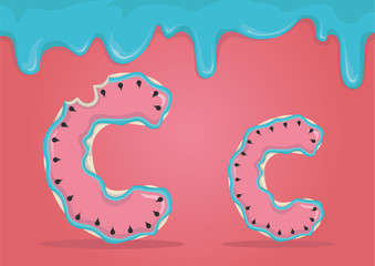 Whole and bitten delicious Latin letters C in the form of cookies with watermelon icing.