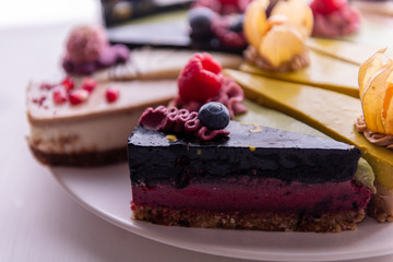 random selection of healthy vegan raw colorful  fruit cakes 