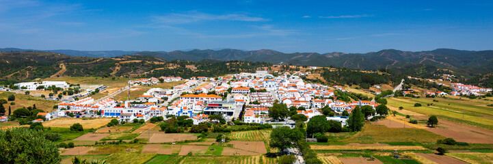 Charming architecture of hilly Aljezur, Algarve, Portugal. View to the small town of Aljezur with...