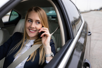 Beautiful businesswoman is driving her car