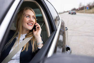 Beautiful businesswoman is driving her car
