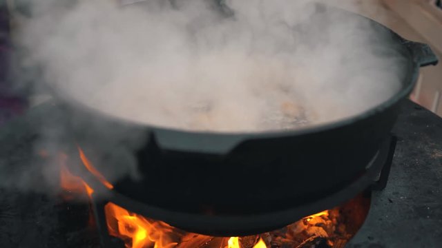A large vat of soup on a street food court