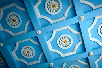 outdoor stucco molding on the ceiling with painted blue backgreound
