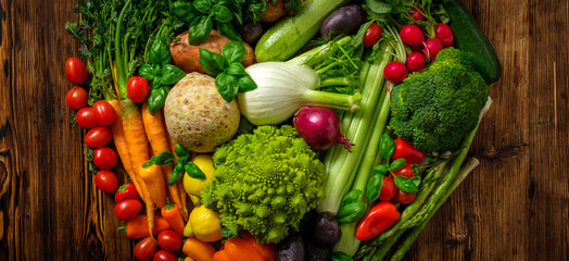 Assortment of fresh vegetables on wooden background