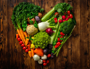 Assortment of fresh vegetables on wooden background