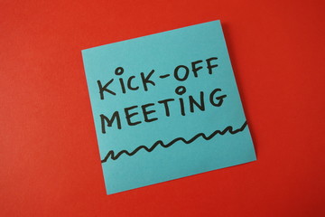 Kick-off meeting text handwritten on blue sticker