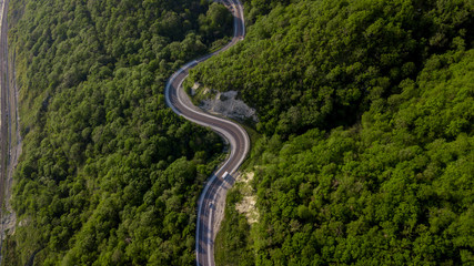 Top view of cars driving on zig zag winding mountain road