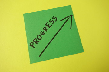 Word progress with up arrow handwritten on sticker