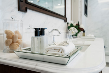 beautiful amenity hotel set on white marble counter in bathroomm